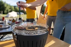 LotusGrill Mini Houtskoolbarbecue - Rood -Zwembad Tuin lotusgrill in gebruik hamburger 1